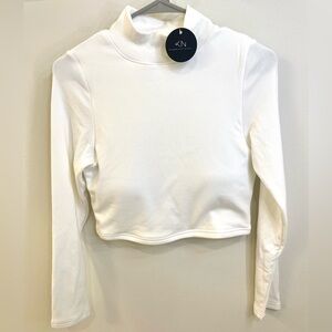NWT in bag. Size XS. Ribbed White mock neck crop long sleeve. Klassy network.